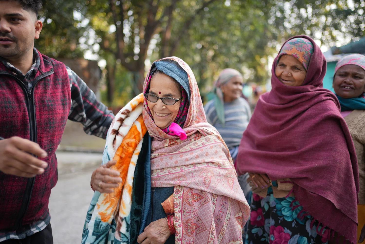 Women with blankets gathered at the community distribution.