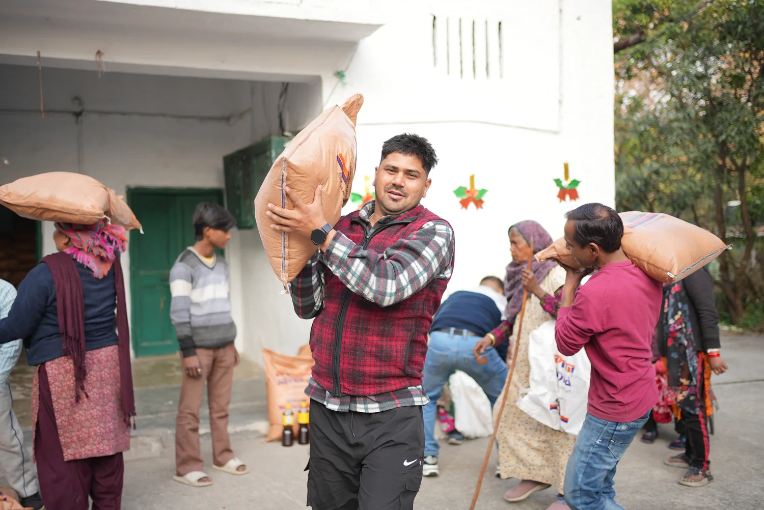 A team member lifts a ration sack to help with collection.