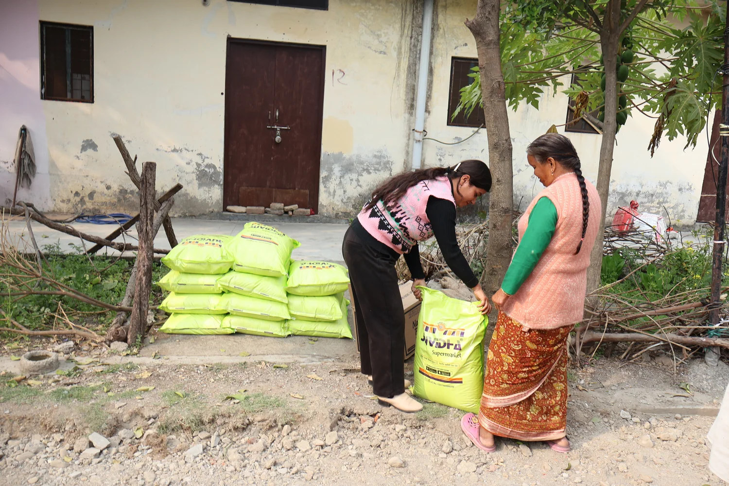 A flour bag is positioned for a resident at the community ration handover.