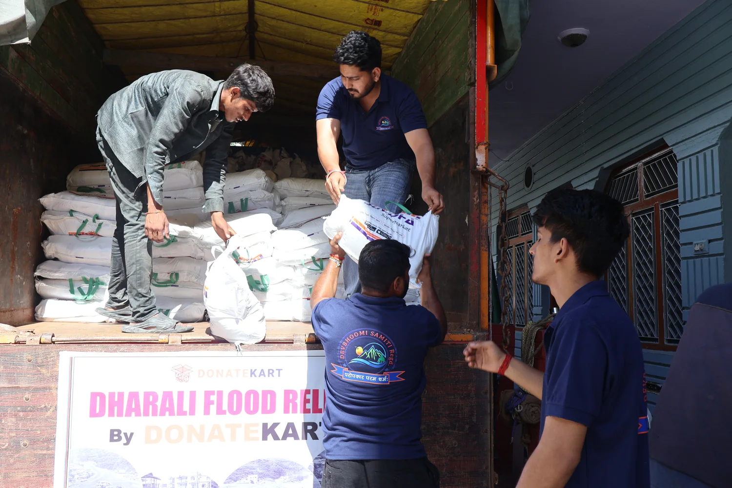 Team members arrange sacks inside the relief truck before distribution.