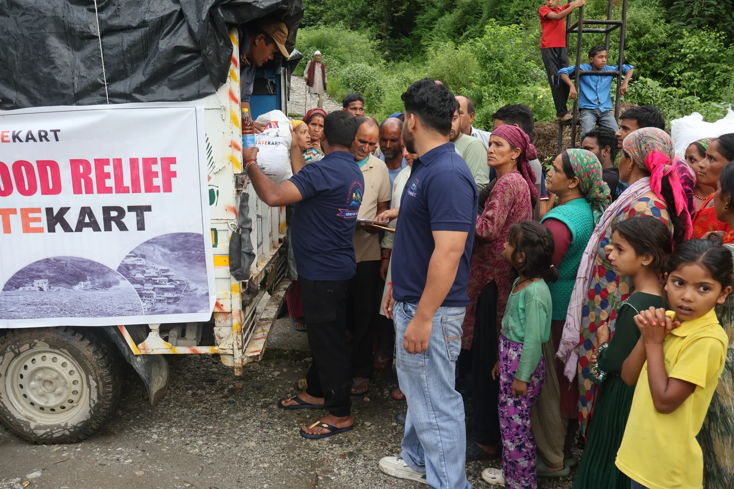 Team members assist with another ration handover during the relief activity.