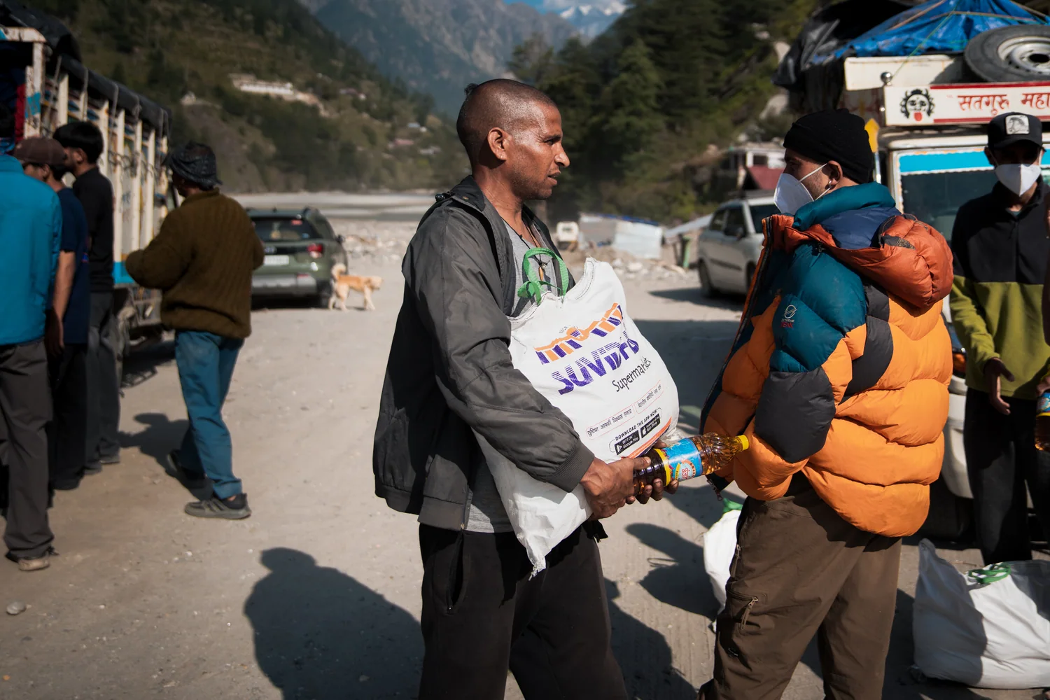 A resident collects a sack of food supplies during the Dharali relief activity.
