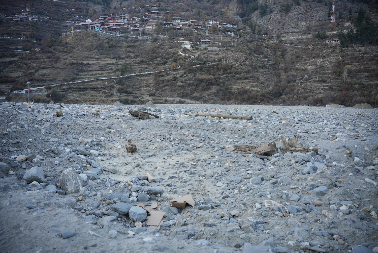A broad view of debris across the valley floor in Dharali.
