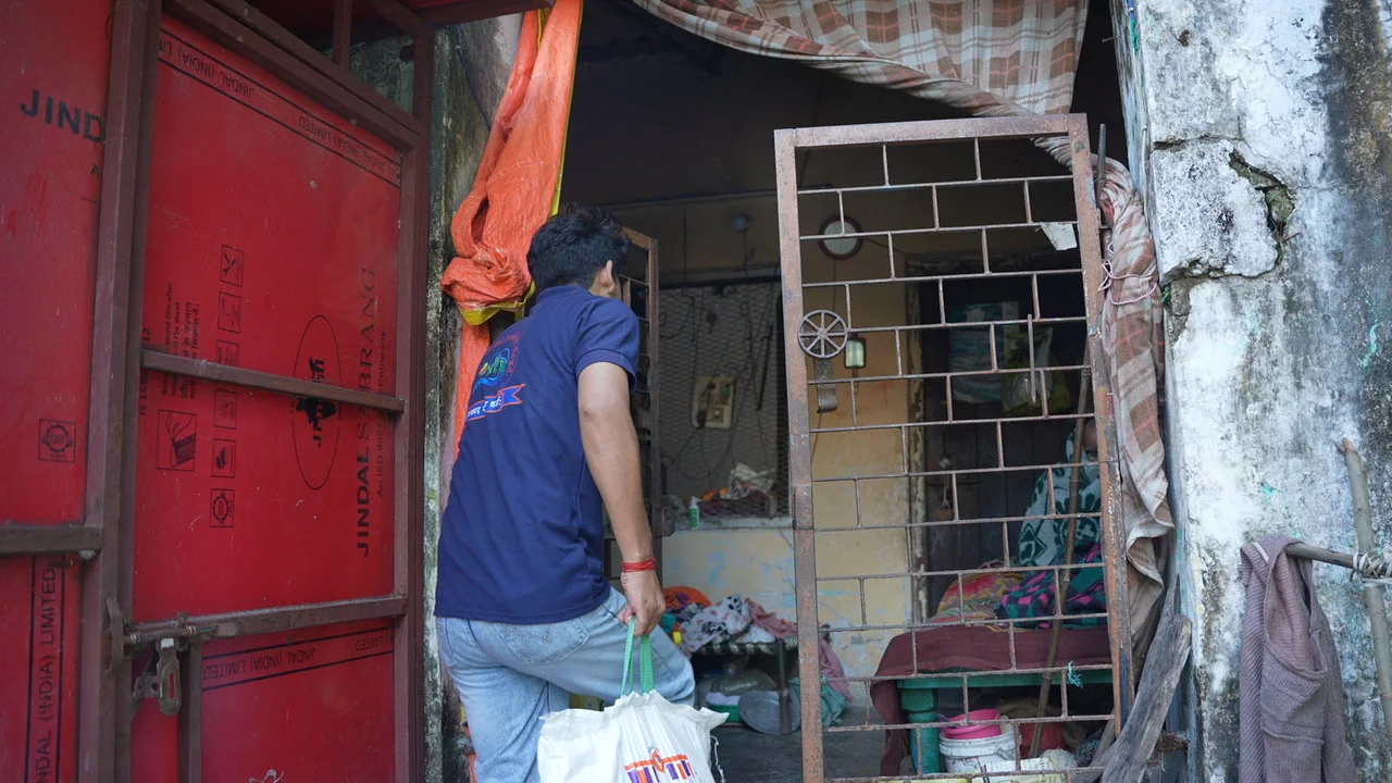 A team member brings food supplies to a resident’s doorway.