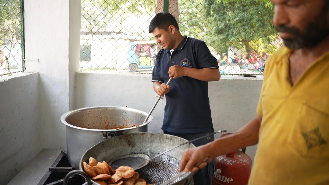 Food preparation in large pans before the community meal.