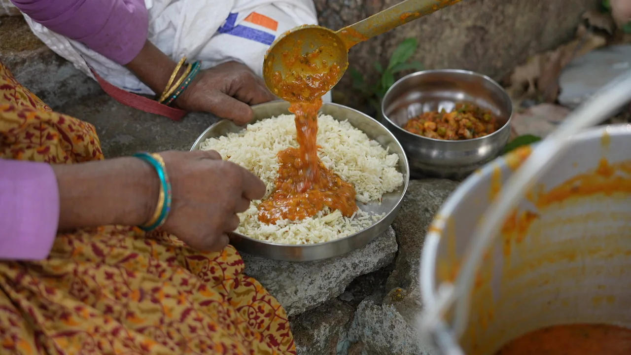A portion of food is served onto a resident’s plate.