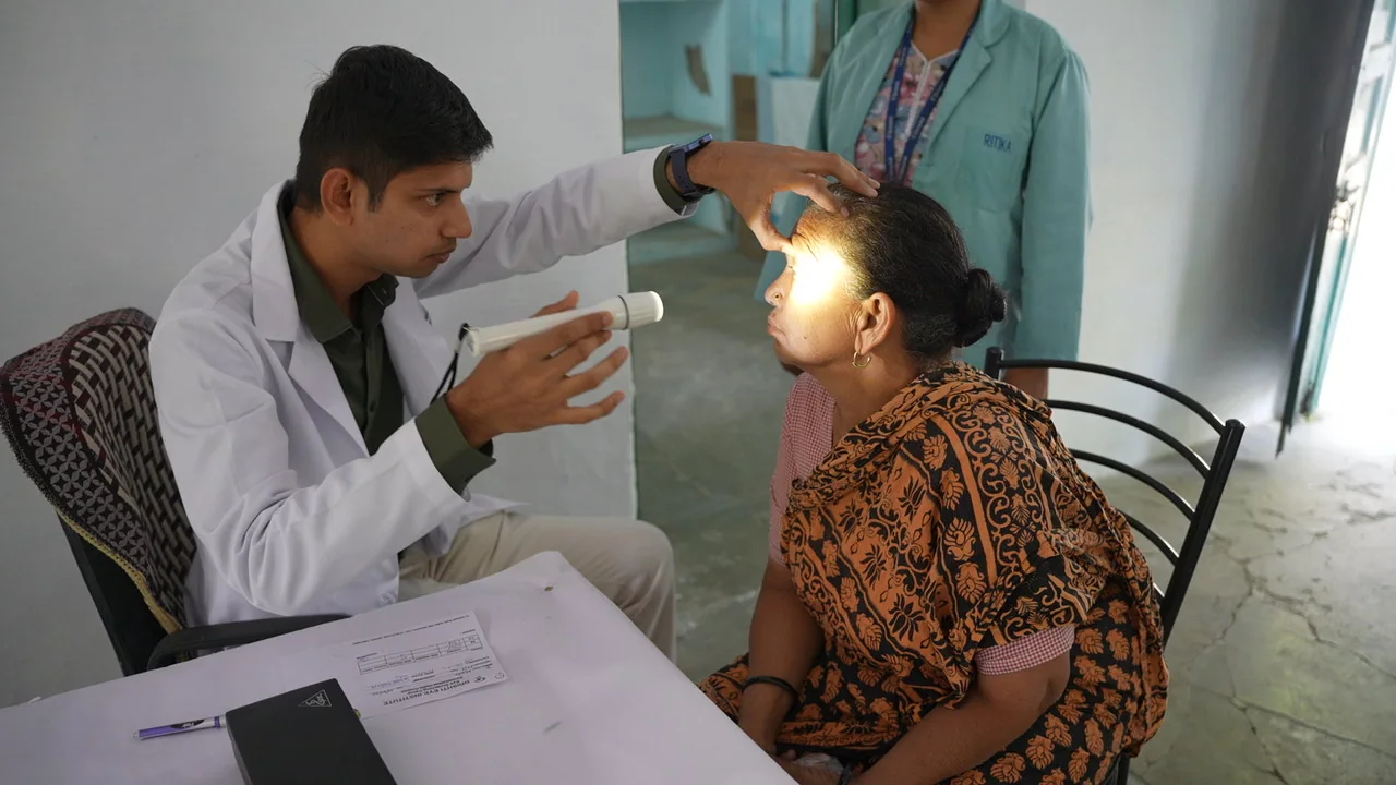 An eye examination using a light during the community health session.