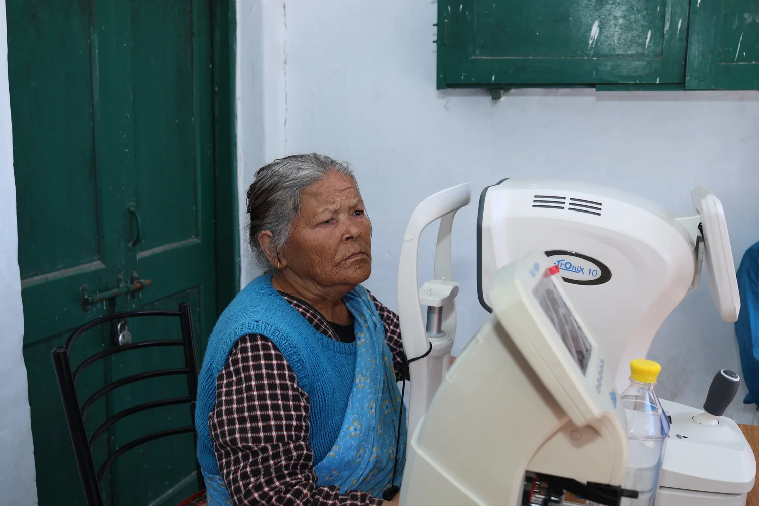 An older resident taking part in an equipment-based eye check.