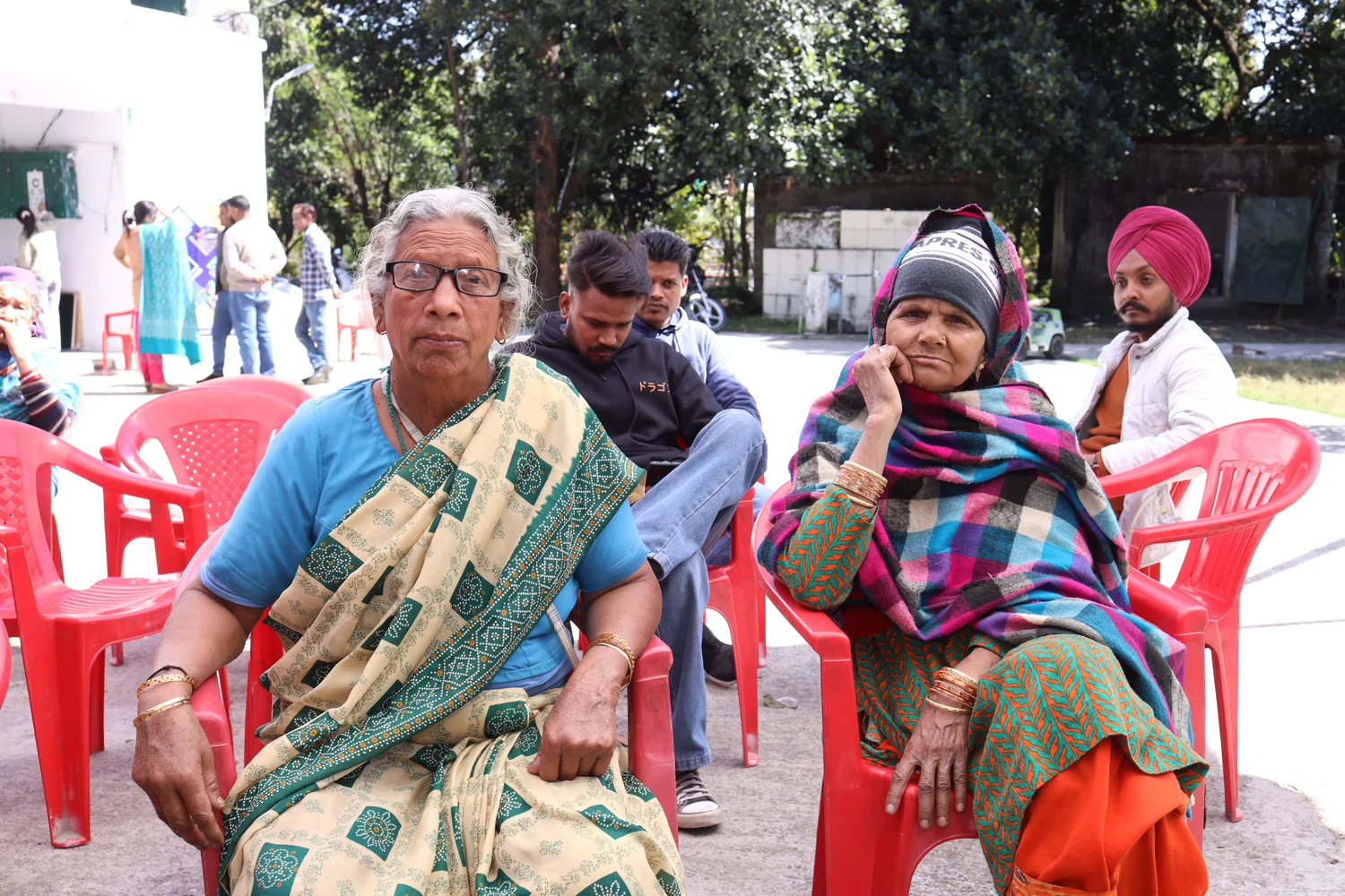 Residents seated in the waiting area of the health outreach camp.