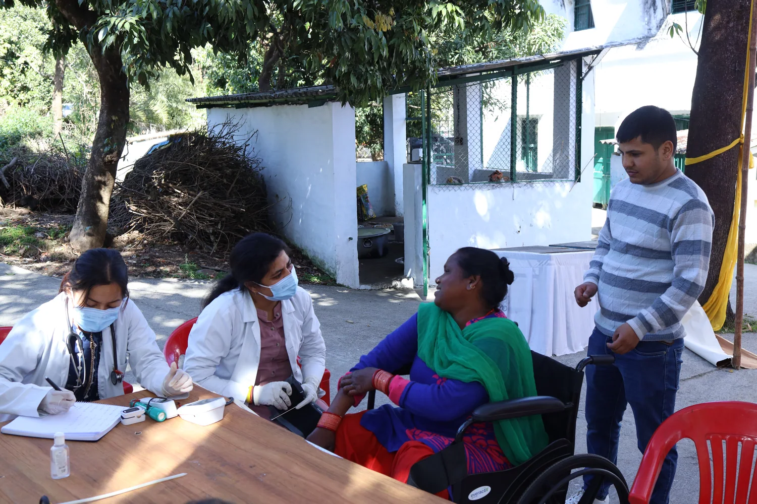 A resident and team members together at the consultation area.