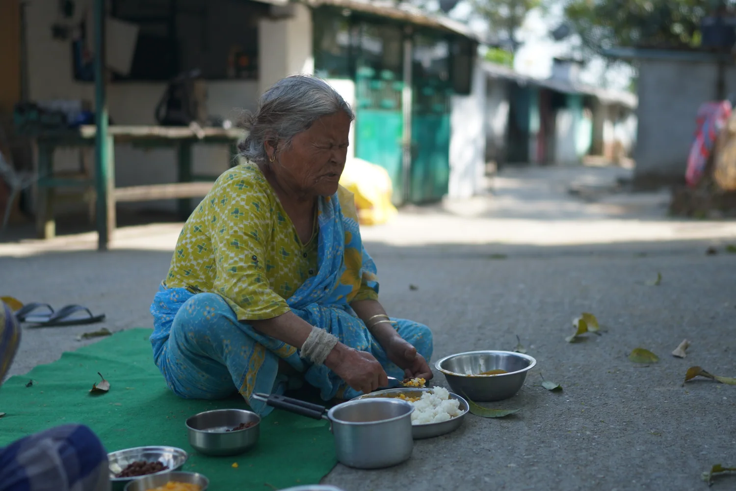 A resident with her meal plate and bowl during the food-support activity.