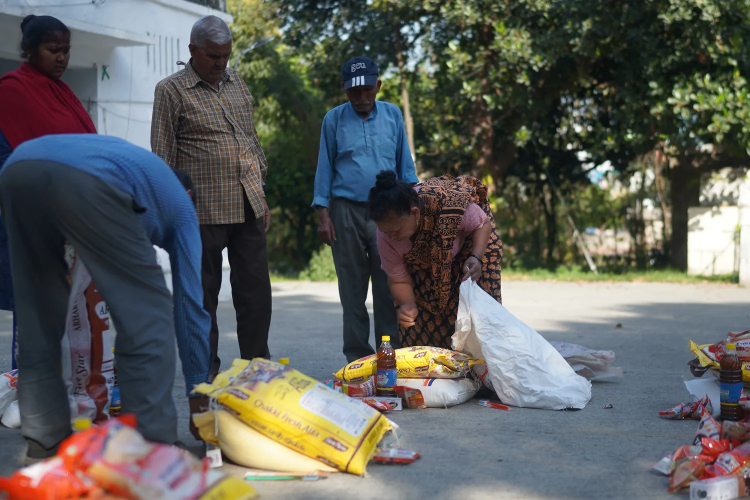 Ration bags are gathered and lifted during the distribution.