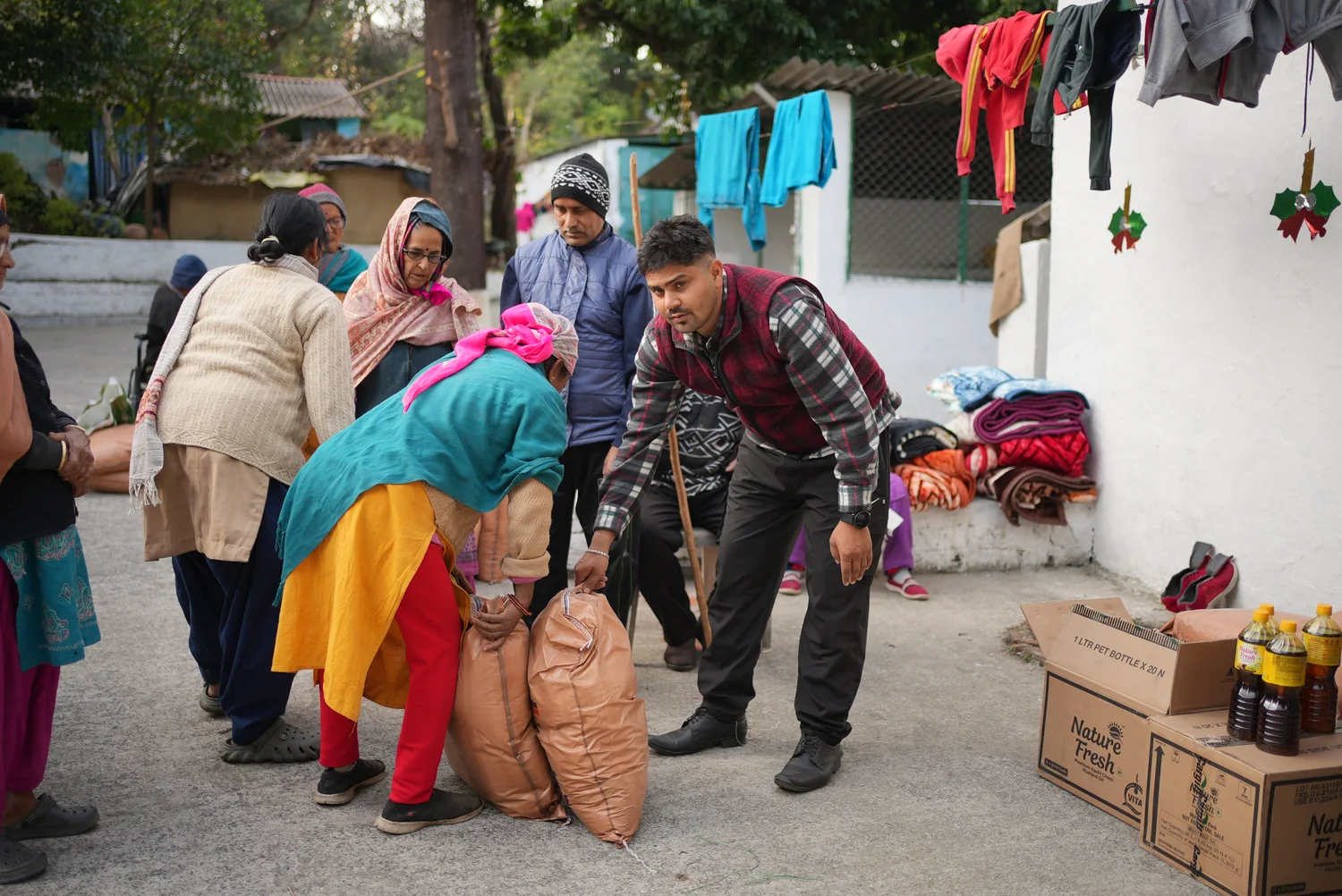 Team members and residents handle supplies at the winter ration distribution.