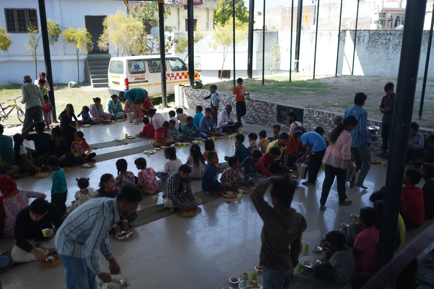 A wide view of the covered community-meal space.