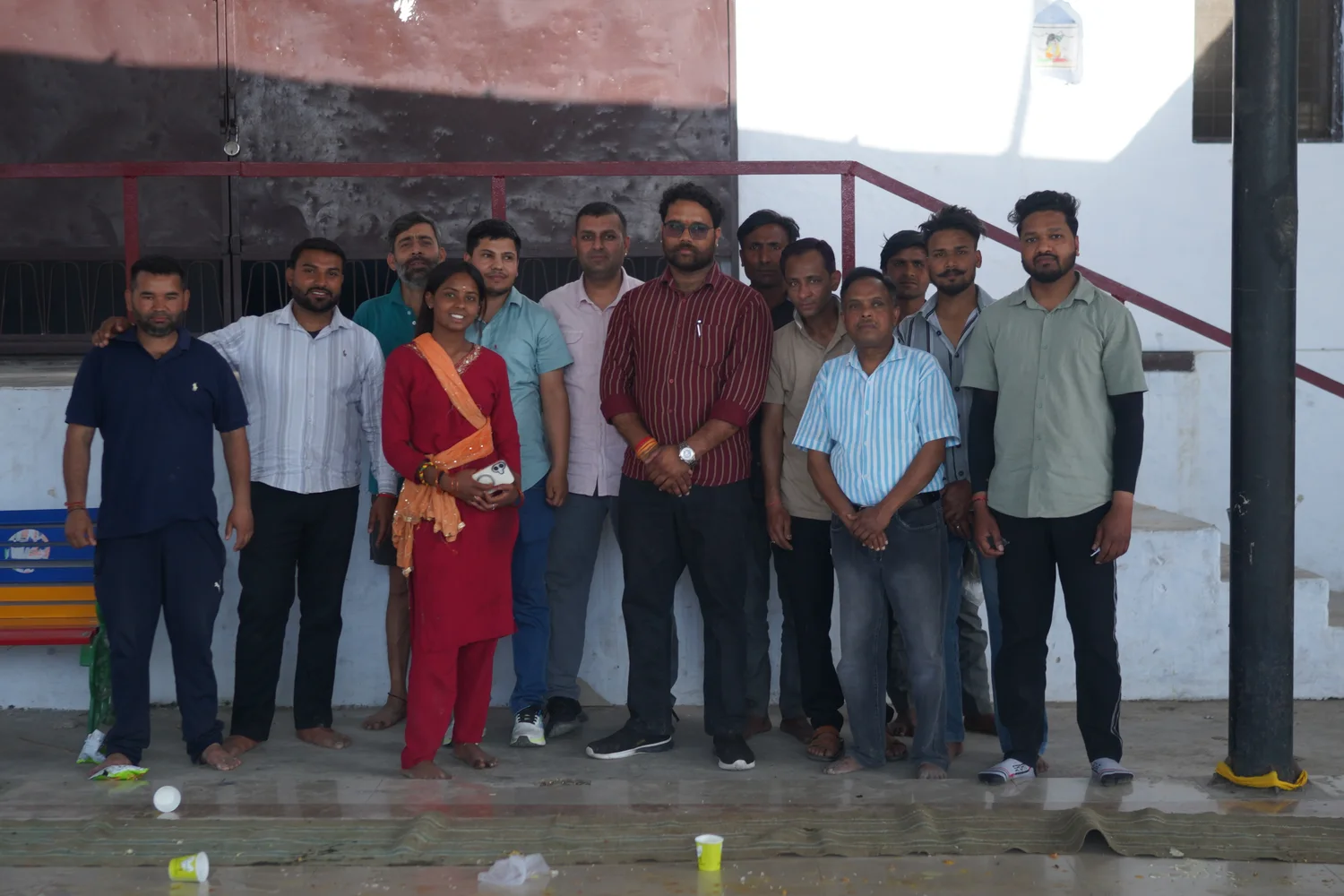A group photograph taken beside the community gathering space.