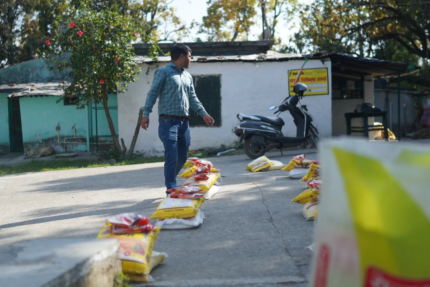 Ration supplies arranged across the outdoor handover area.