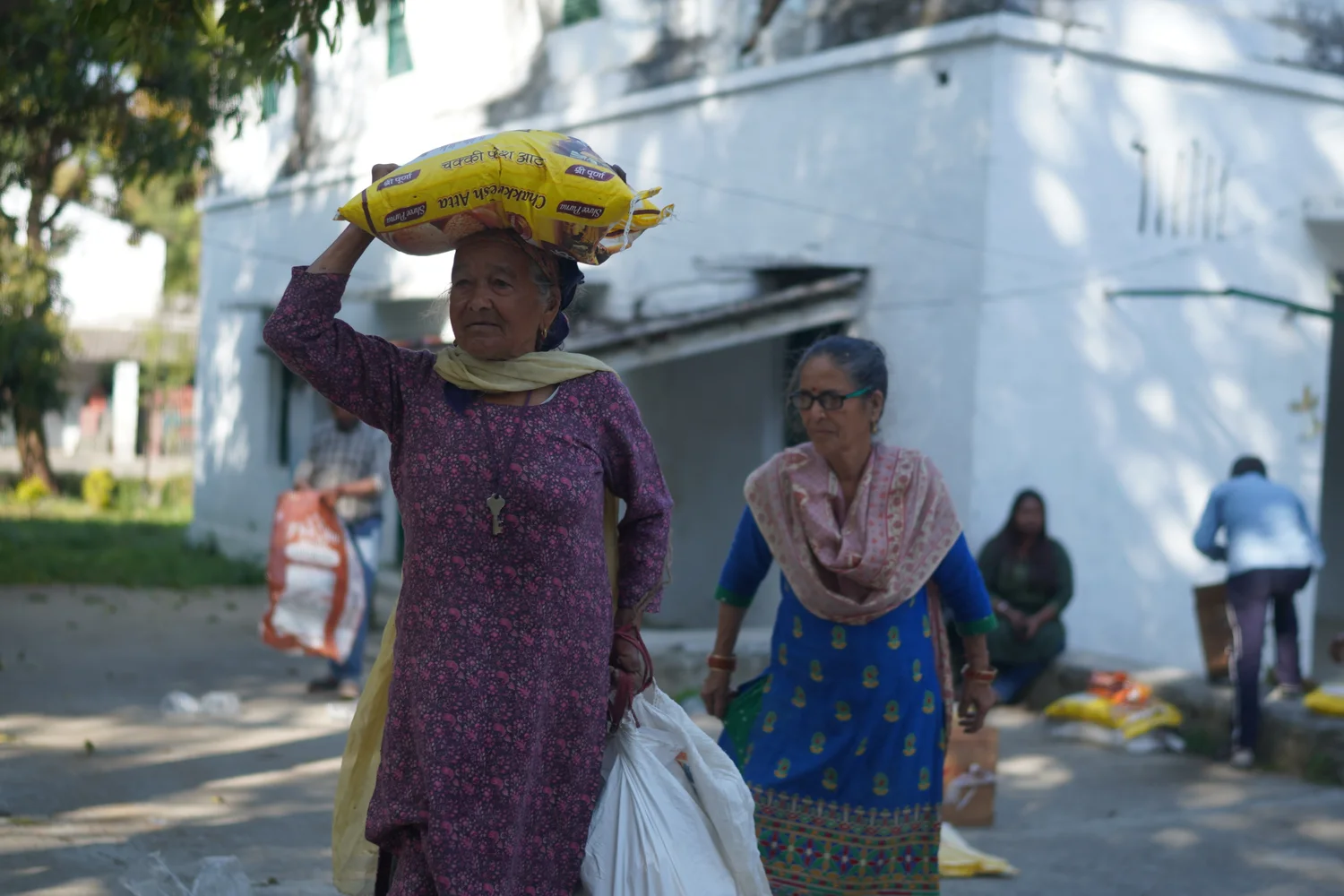 A resident carries a sack after collecting supplies.