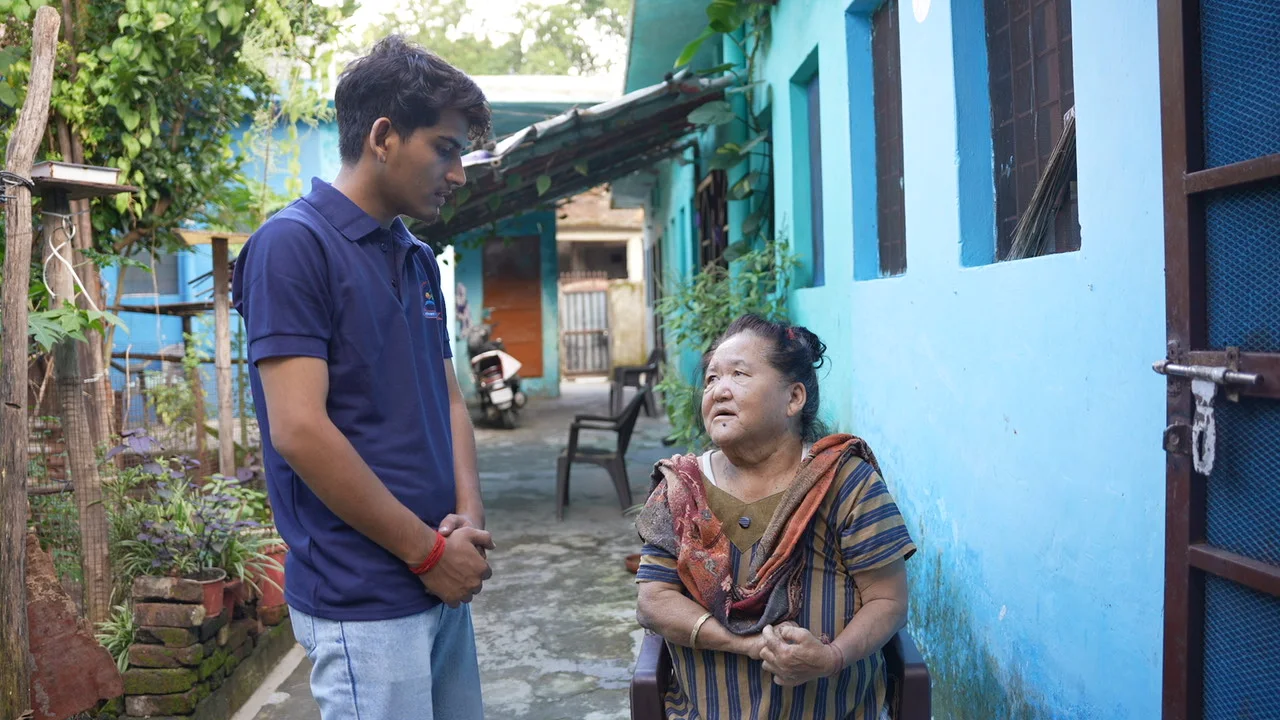 Conversation with a resident outside her home.