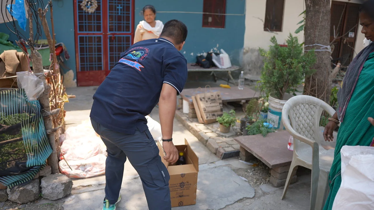 A carton is carried towards the community handover area.