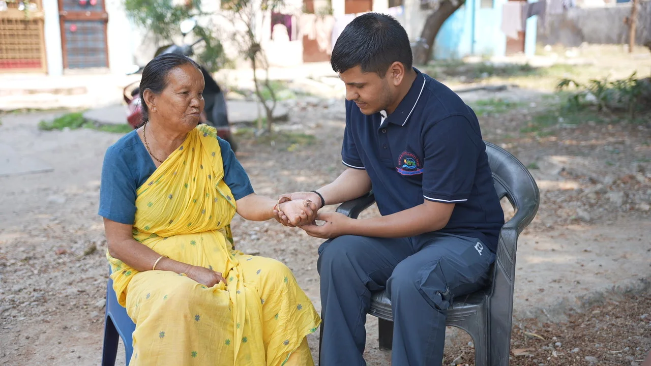 A conversation with an older woman during a community visit.