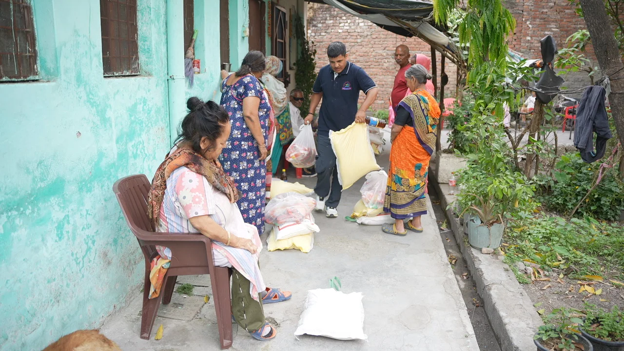 Residents and visitors meet along a residential lane.