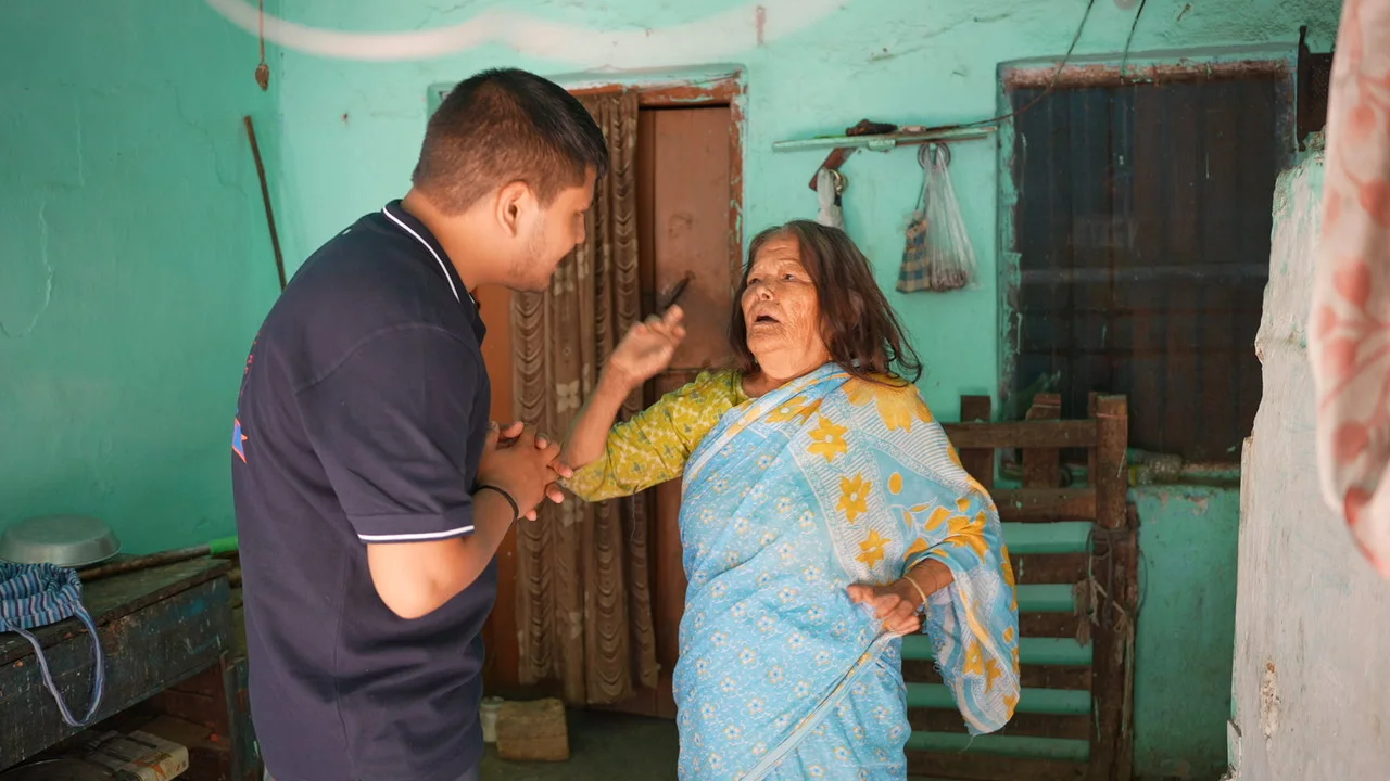 Mealtime assistance for an older woman at her doorway.