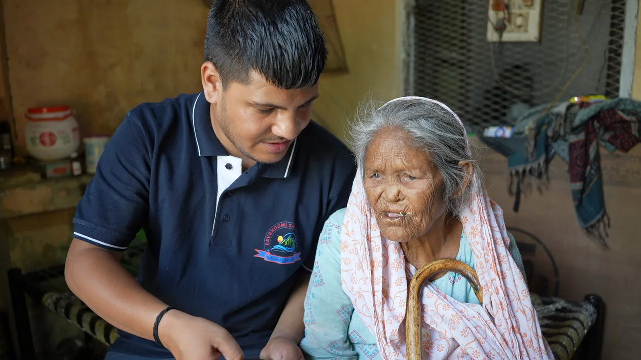 A visitor offers company to an older woman in her home.