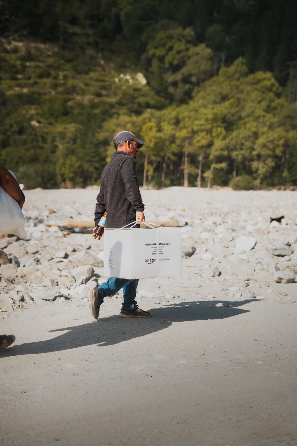 A carton is carried away from the relief distribution area.
