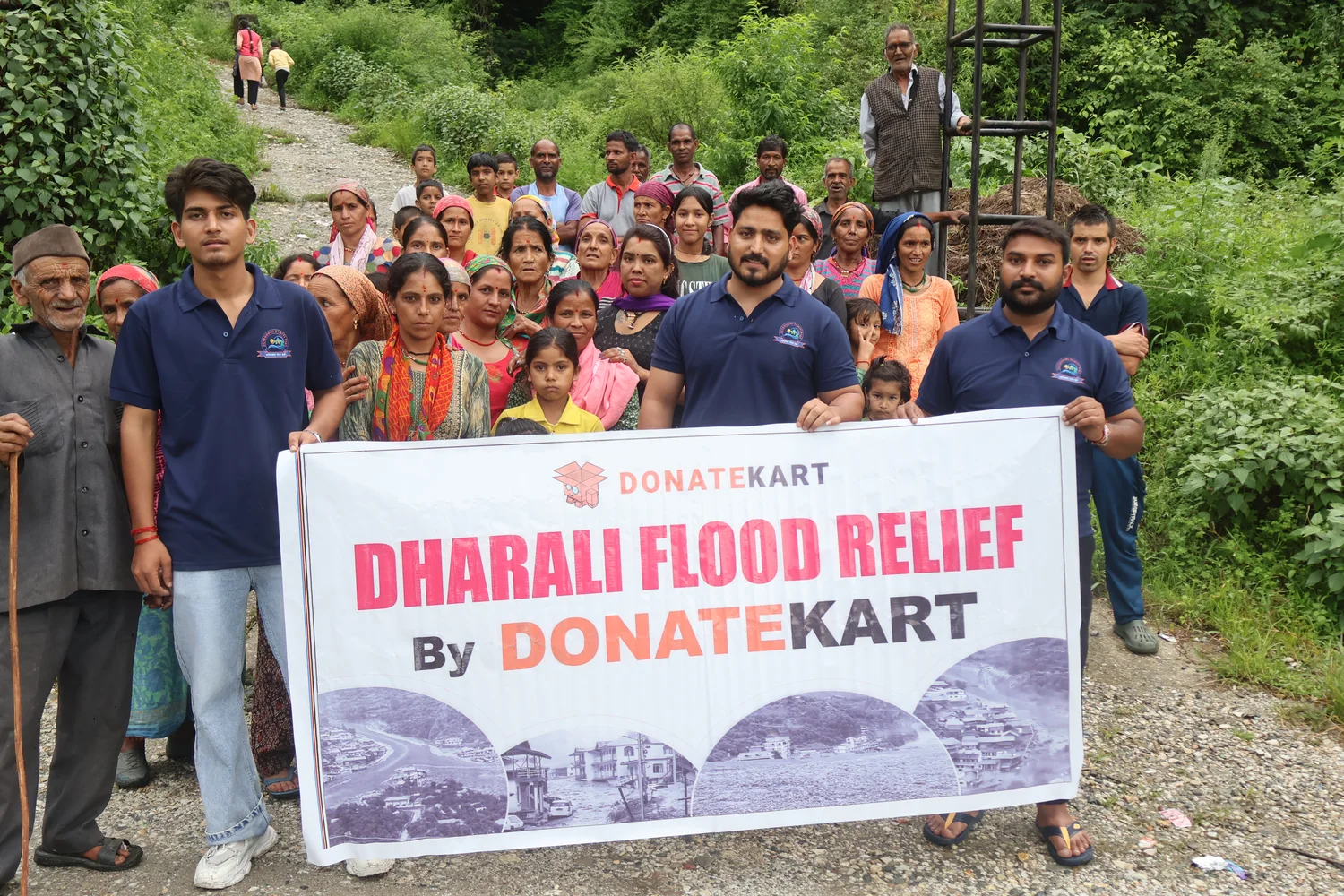 Community members and the relief team gather with a programme banner.