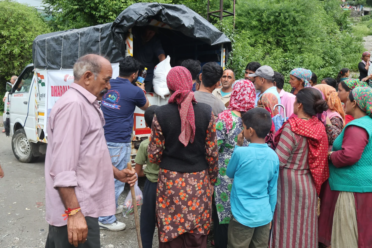 People gather at the rear of the loaded vehicle during the programme.