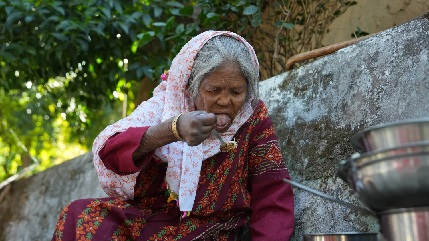 A resident takes a meal beside the community seating area.