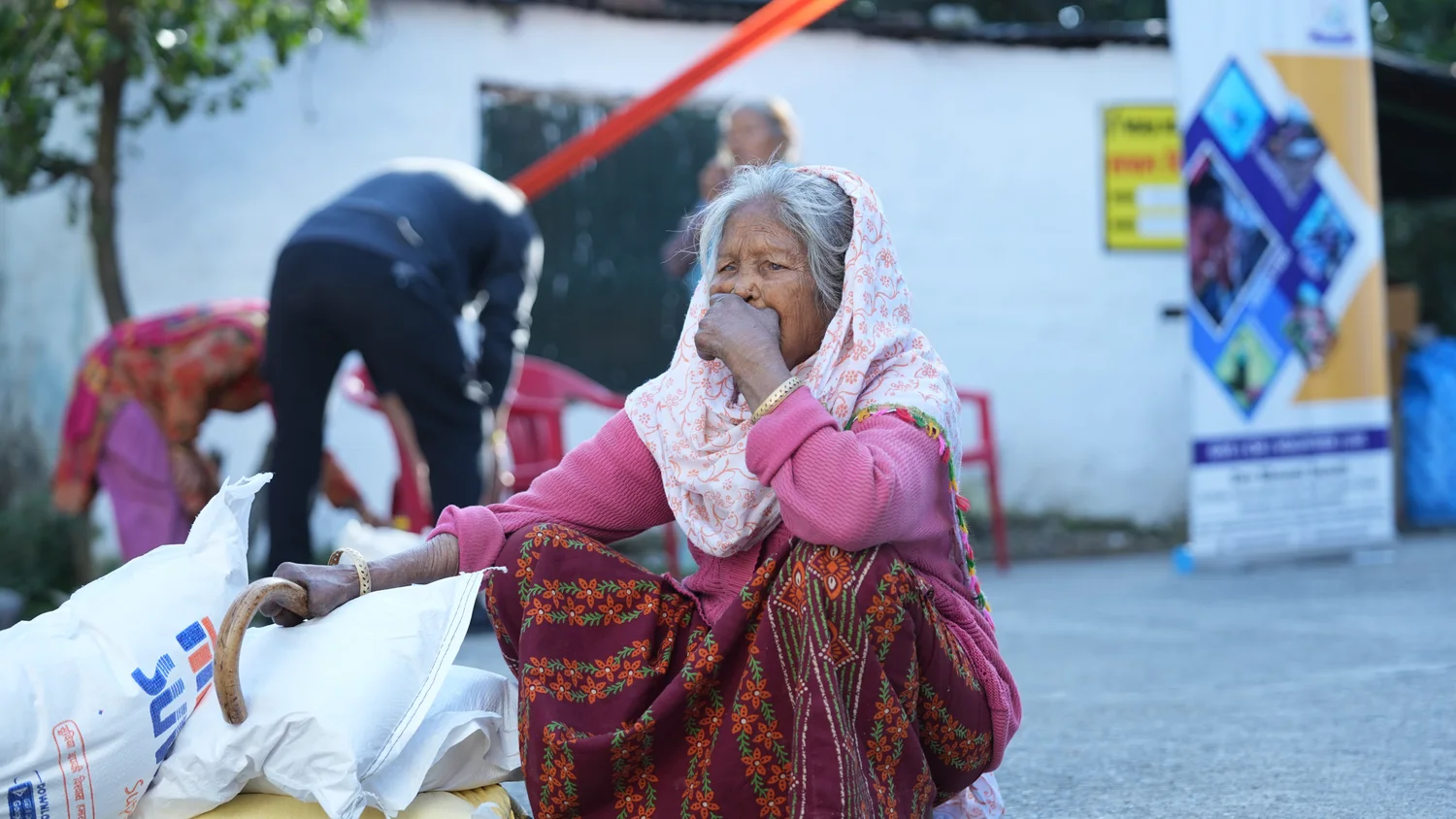 A resident holds a refreshment while the team works nearby.