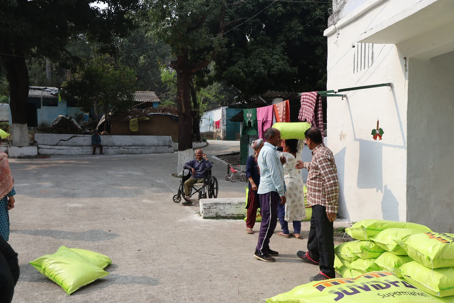 Stacked ration sacks beside a building in the shared courtyard.