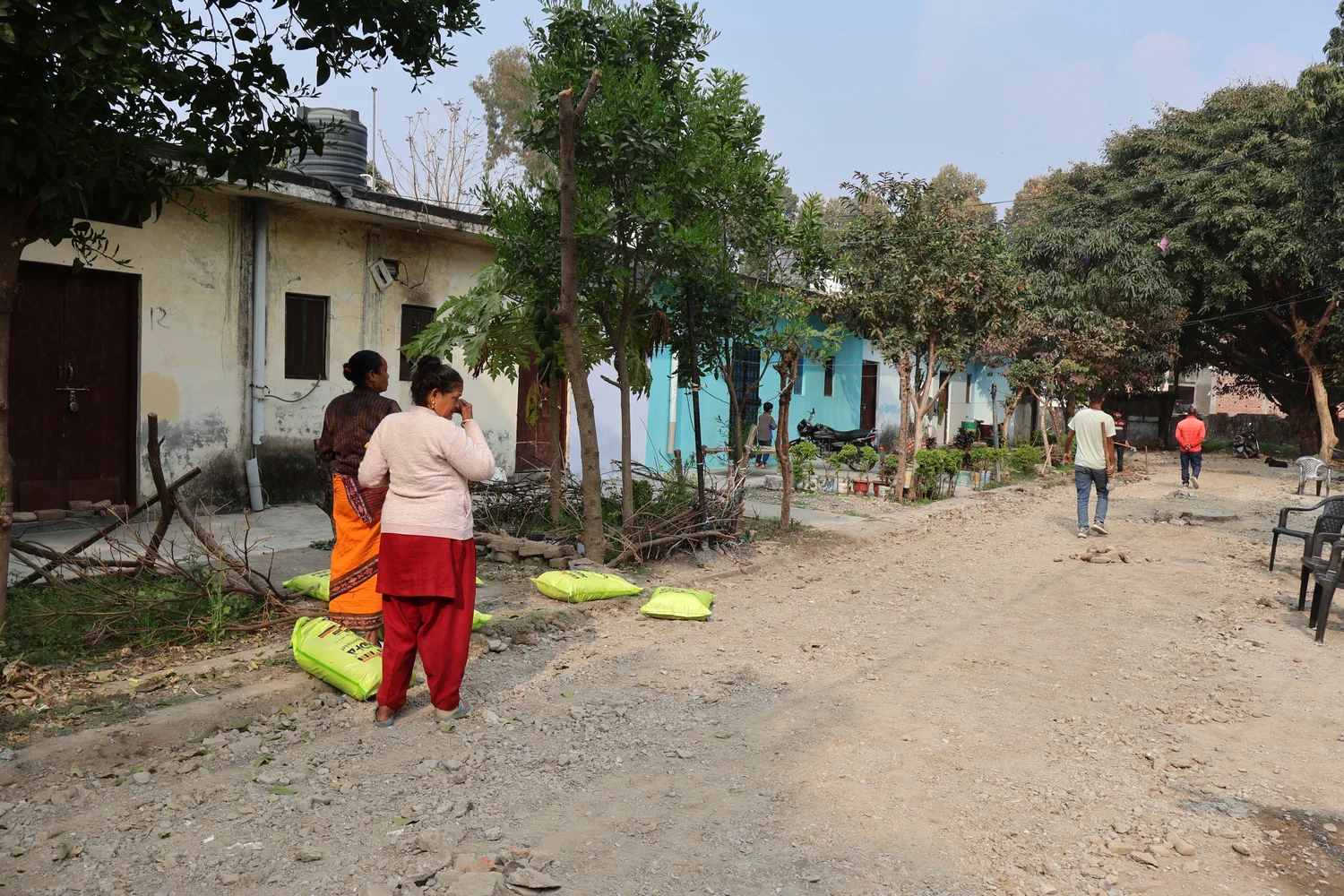 A resident carries a ration bag away through the neighbourhood.