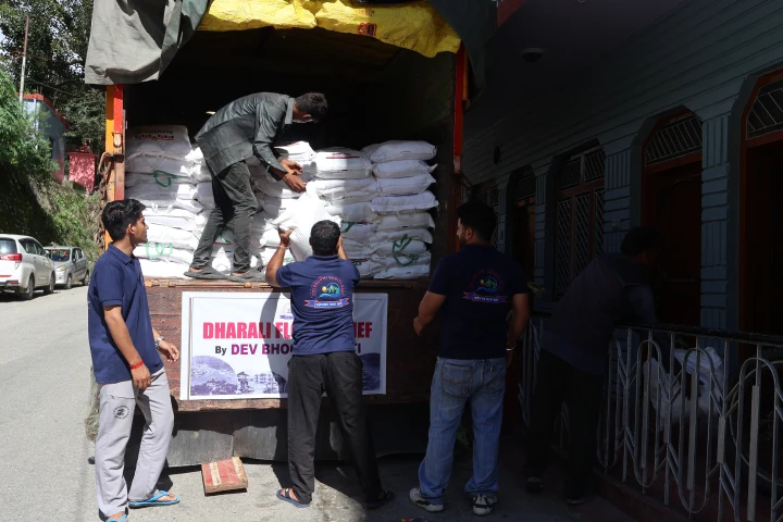 Volunteers organizing food supplies in the back of a relief truck