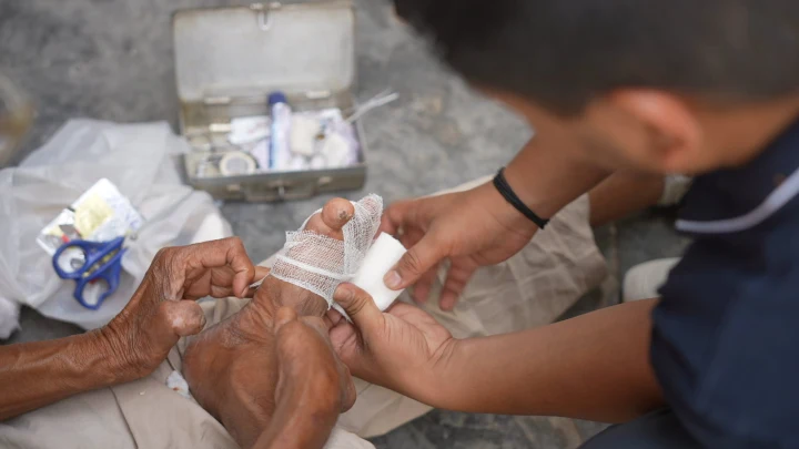 Close-up of a volunteer providing practical assistance during a home visit