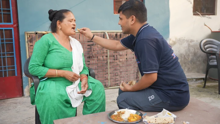 Community members sharing food during a Dev Bhoomi Samiti visit