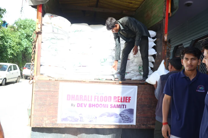 Team members arranging sacks on a Dharali flood relief truck