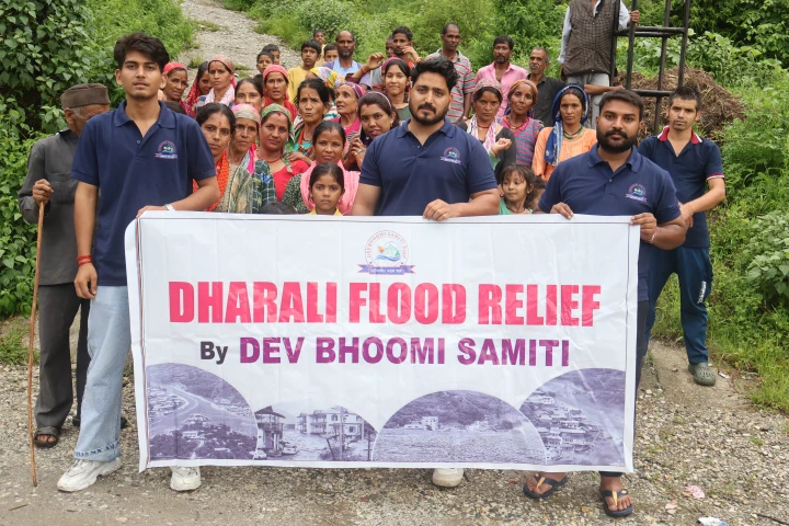Dev Bhoomi Samiti volunteers holding a Dharali Flood Relief banner