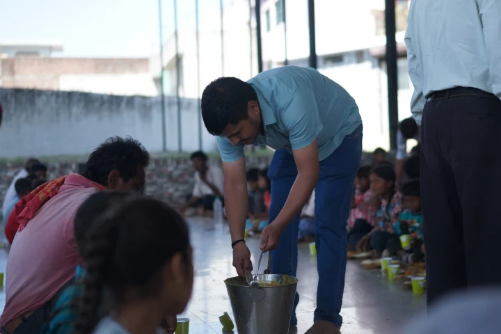 Dev Bhoomi Samiti community meal served to people seated in rows
