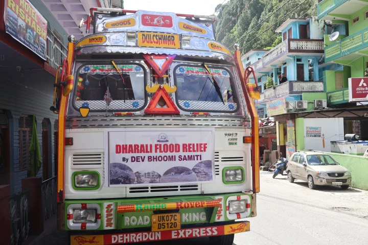 Dev Bhoomi Samiti truck displaying a Dharali Flood Relief banner