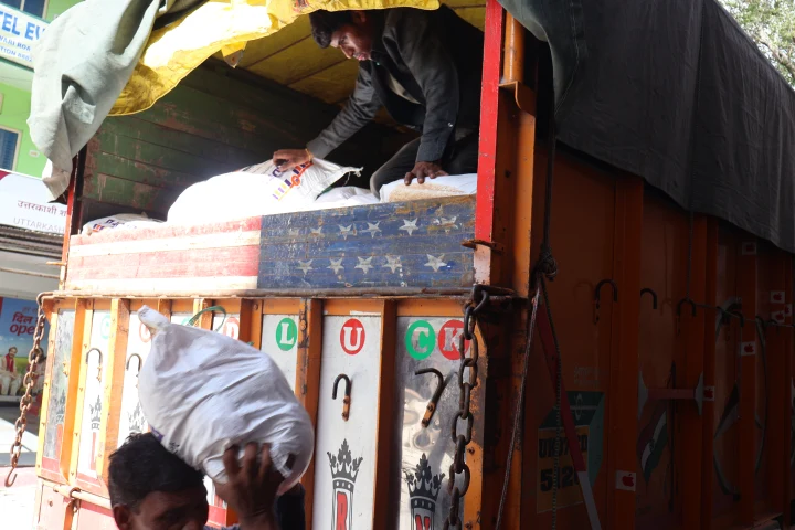 Sacks of supplies being loaded into a relief truck