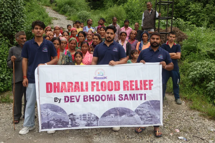 A group of volunteers with the Dev Bhoomi Samiti Dharali Flood Relief banner